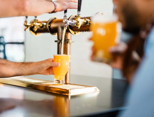 Employee pouring a beer at the Brakeman