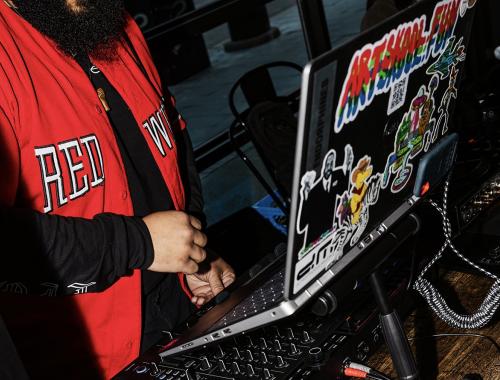 Man DJ'ing on laptop at The Brakeman, Detroit