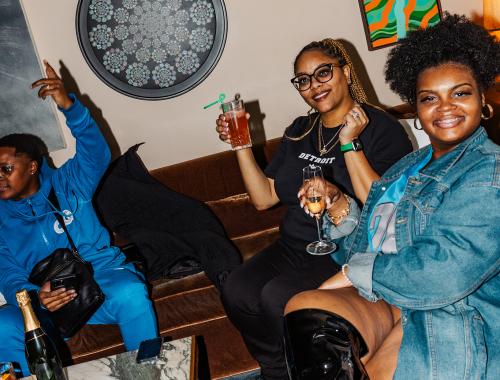 Friends raise a toast in the Living Room