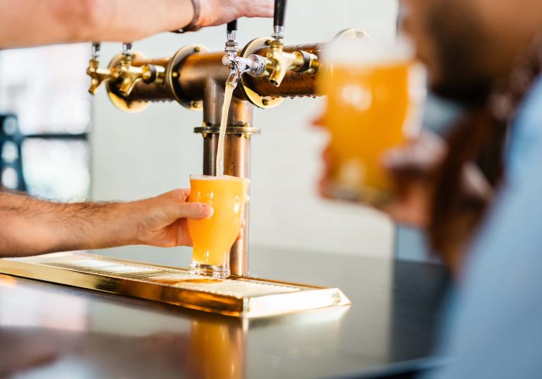 Employee pouring a beer at the Brakeman