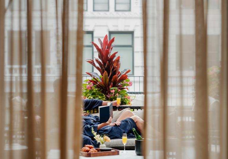 A couple relaxes on a penthouse terrace at the Shinola hotel