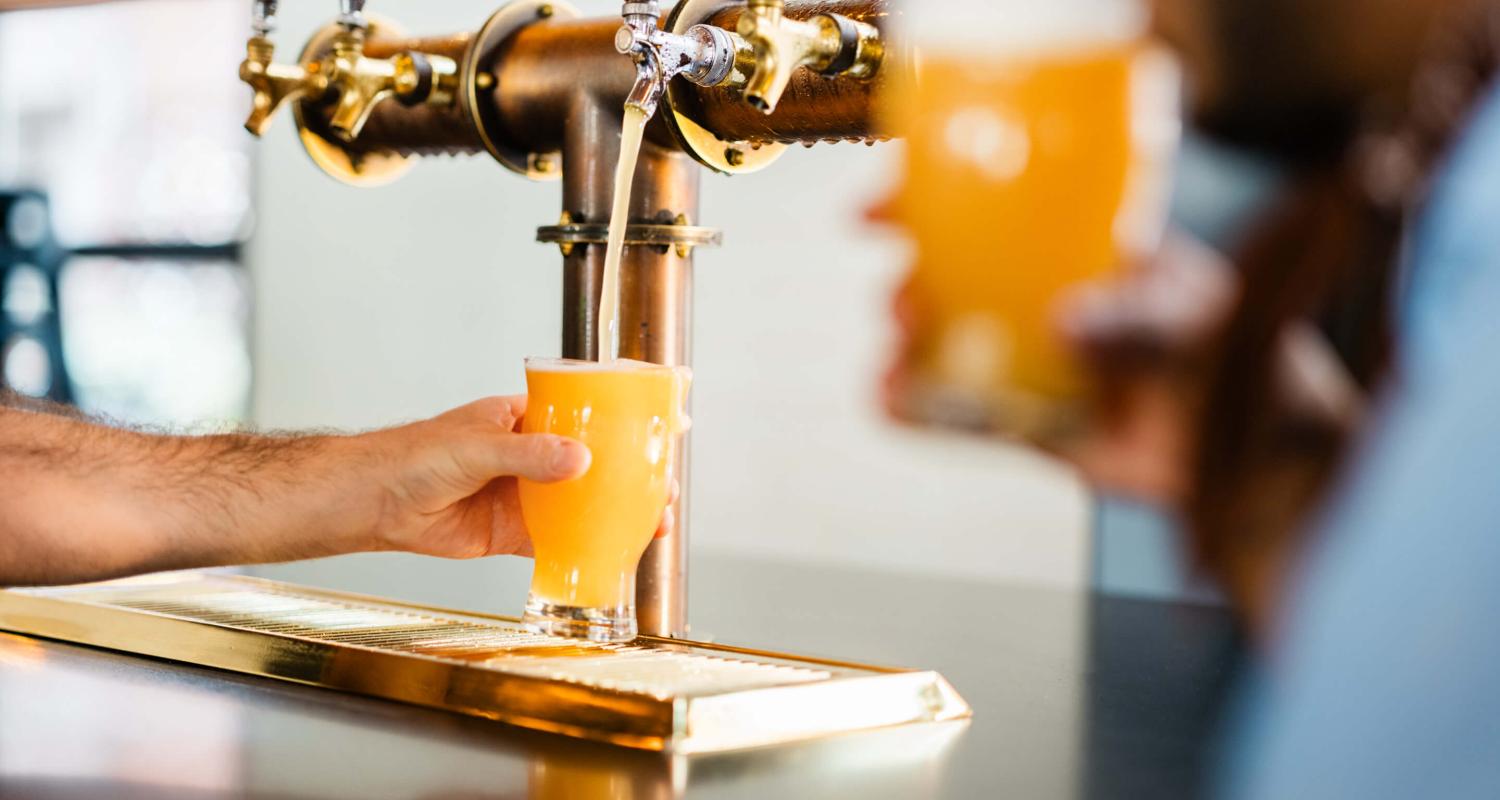 Employee pouring a beer at the Brakeman