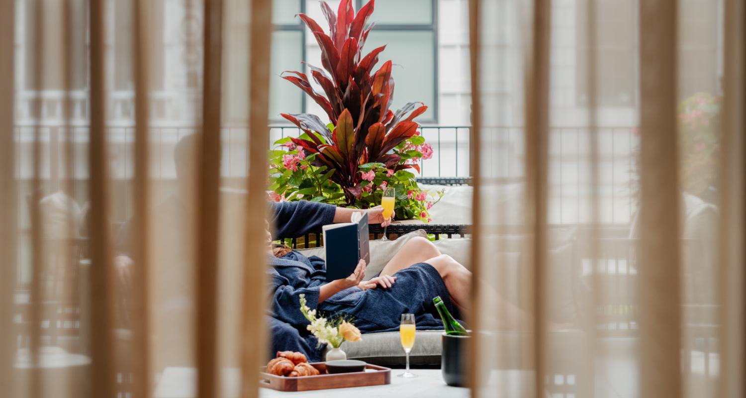 A couple relaxes on a penthouse terrace at the Shinola hotel