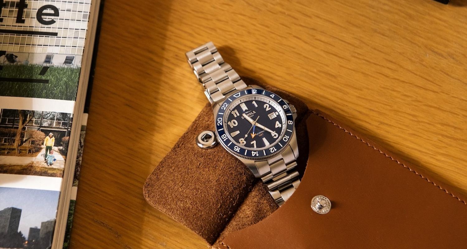 Shinola watch peeking through travel pouch