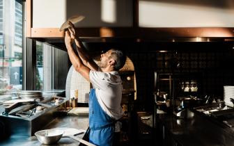 Chef tossing pizza dough