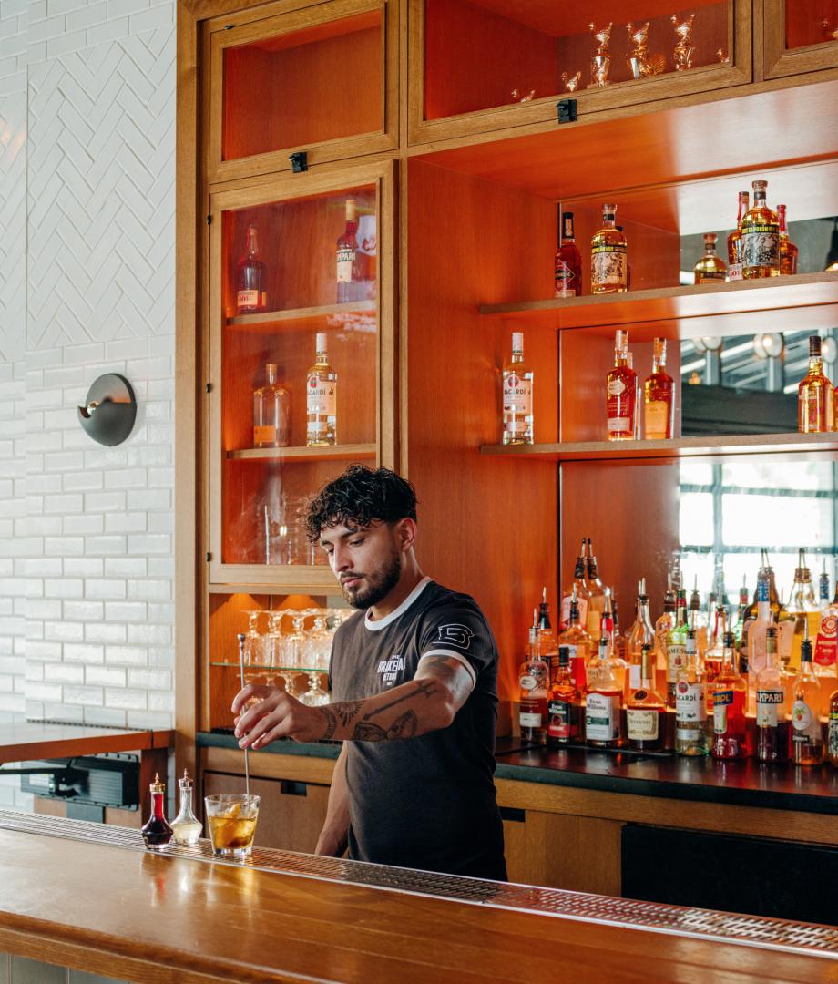A bartender at The Brakeman, Detroit making a mixed drink