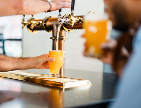 Employee pouring a beer at the Brakeman