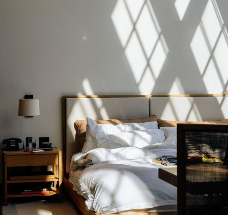Shinola Hotel Bed with dine in meal on covers 