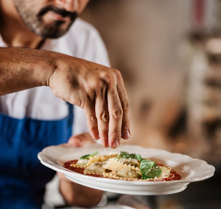 Chef finishes a dish at San Morello