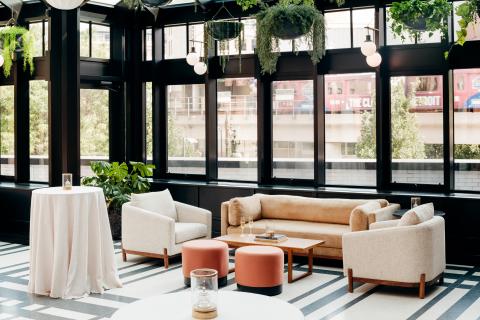 Room with chairs, couch and tables set up 